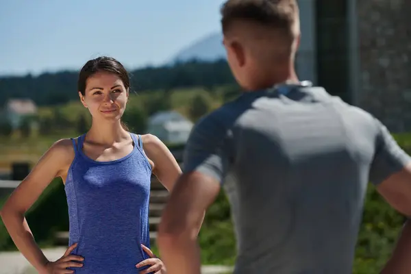 stock image In a serene moment of post-run tranquility, a romantic couple rests together, embodying both exhaustion and affection after a rigorous training session.