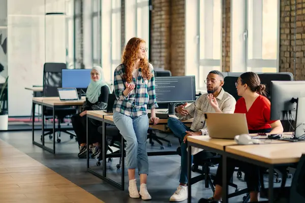 stock image A diverse group of young business individuals congregates in a modern startup coworking center, embodying collaborative innovation and a dynamic atmosphere.