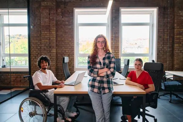 stock image A diverse group of business professionals collaborates in a modern startup coworking center, utilizing a mix of paper-based and technological tools such as mobile phones and computers .