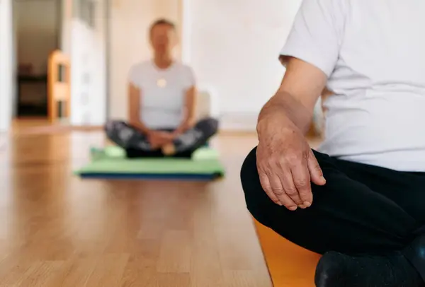 stock image A senior man, captured in close-up, is immersed in meditation and relaxation while practicing yoga, embodying tranquility and mindfulness.