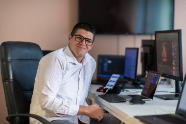 Bir programcı ofisinde otururken akıllı telefon uygulamalarını özenle test ediyor. Yüksek kalite fotoğraf