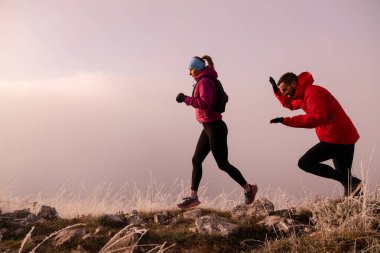 Dağ yolunda koşan bir çiftin izini sürüyorum. Bir çift sabahın erken saatlerinde kros koşusu yapıyor..