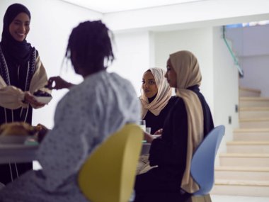 A woman in a hijab extends a platter of dates to her diverse family, creating a scene of unity and joy as they come together to break their fast during the holy month of Ramadan, symbolizing the clipart