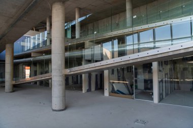 Yapım aşamasındaki modern bir iş binasının büyüleyici bir görüntüsü, çiğ endüstriyel iç mekânını, gün batımının sıcak, altın sarısı renkleri ile yıkanmış çelik kirişleri ve beton duvarlarıyla sergiliyor.. 