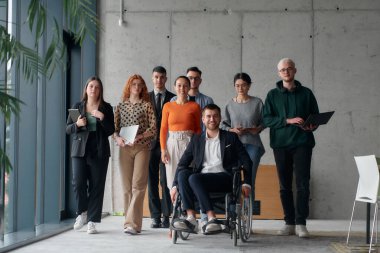 Çağdaş bir ofiste tekerlekli sandalyede müdürle işbirliği yapan çok ırklı iş adamları..