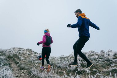 Dağ yolunda koşan bir çiftin izini sürüyorum. Bir çift sabahın erken saatlerinde kros koşusu yapıyor..