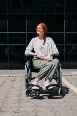 In front of a modern corporate building, a young woman sitting in a wheelchair confidently, symbolizing empowerment, inclusivity, and the strength to overcome challenges in the business world. clipart