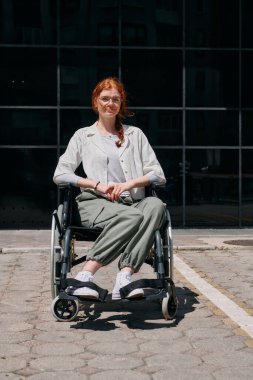 In front of a modern corporate building, a young woman sitting in a wheelchair confidently, symbolizing empowerment, inclusivity, and the strength to overcome challenges in the business world. clipart