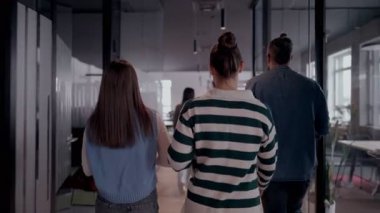 Modern bir açık mekan ofisinin iş ekibi birlikte yürüyor. Çeşitli iş adamları tartışırken gülümsüyor. Başarılı karma ırk meslektaşları yeni bir projede işbirliği yapıyorlar