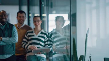 Modern bir ofiste, açık bir alanda işbirliği yapan çeşitli, etnik çeşitlilikte girişimci ve liderlerden oluşan bir iş ekibi. Takım çalışmaları, motivasyonları ve ortaklıkları şirketlerin büyümesini ve başarısını besliyor.