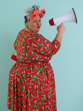 Renkli puantiyeli kıyafetli kendine güvenen bir kadın ve retro başlıklı bir kadın megafona bağırıyor, mavi bir arka plana karşı güçlü bir duygu ve tavır sergiliyor.. 