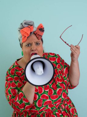 Renkli puantiyeli kıyafetli kendine güvenen bir kadın ve retro başlıklı bir kadın megafona bağırıyor, mavi bir arka plana karşı güçlü bir duygu ve tavır sergiliyor.. 
