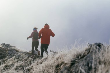 Dağ yolunda koşan bir çiftin izini sürüyorum. Bir çift sabahın erken saatlerinde kros koşusu yapıyor..