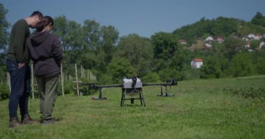 Bir tarımsal dron, akıllı tarım, hassas tarım ve sürdürülebilir büyüme ve verimli ürün yönetimi için yenilikçi teknoloji sergilenen manzaralı bir dağ vadisinde sıra sıra ekinleri izler.