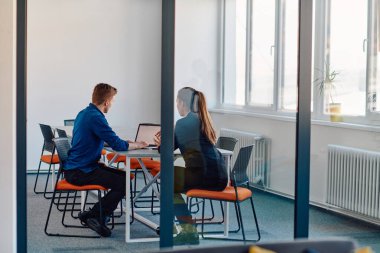 Takım elbiseli bir iş lideri, bilişim sektöründeki çalışanıyla yeni iş projeleri ve mevcut iş sorunları hakkında konuşuyor.. 