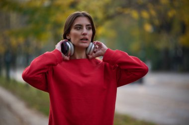 Atletik genç kadın, koşudan ve esnemeden sonra nefes alıyor ve dinleniyor. Sokakta Kadın Eğitimi ve Egzersizleri. Zayıf ve formda bir kız aktif fitness eğitiminden sonra esniyor.. 