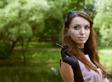 Güzel, zarif genç bayan parkta eğleniyor. Eski tarz. Yaz zamanı..