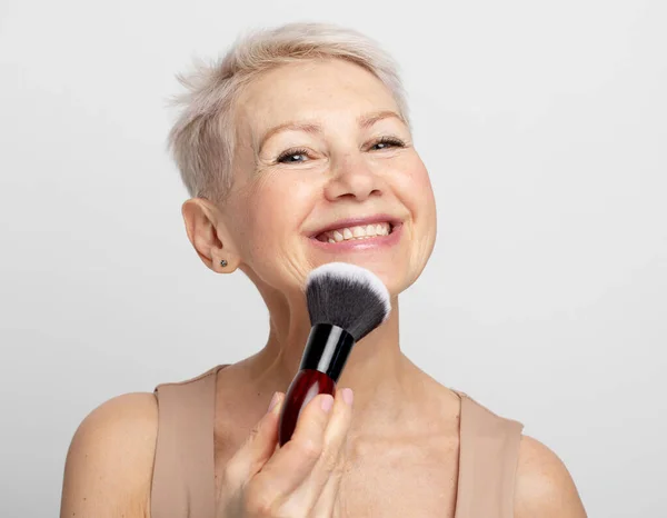 Beauty Portrait Elderly Woman Applying Blush Makeup Brush Grey Background — Stock Photo, Image