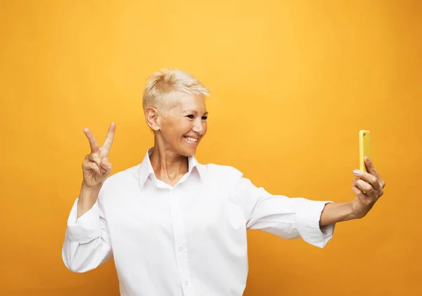 Selfie Time Image Cheerful Mature Old Woman Standing Isolated Yellow — Stock Photo, Image