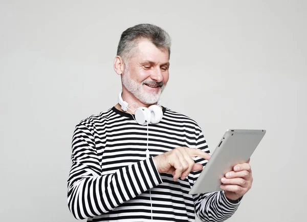 Charming Elderly Man Communicates Friends Using Digital Tablet Headphones Portrait 로열티 프리 스톡 사진