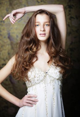 Uzun dalgalı ve parlak saçlı güzel bir kadın. Kıvırcık saçlı, beyaz elbiseli sarışın kadın.