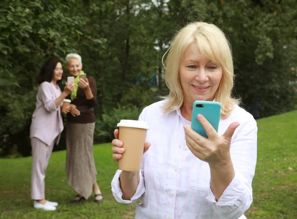 Elderly Lady Watches News Her Phone Distance Background Her Female — Fotografia de Stock