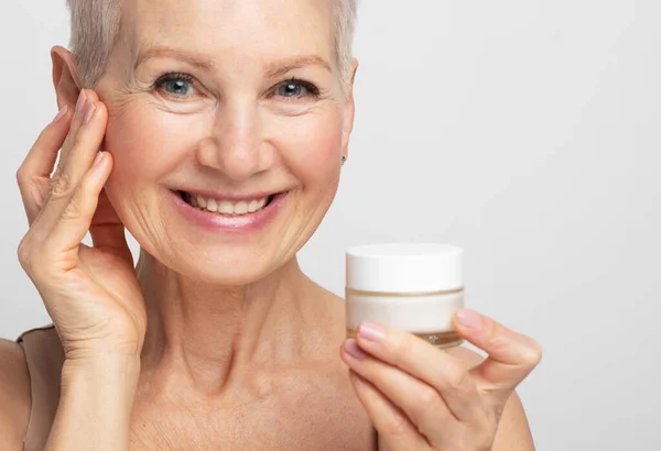 Smiling 60S Middle Aged Mature Woman Putting Tightening Facial Cream — Stock Photo, Image