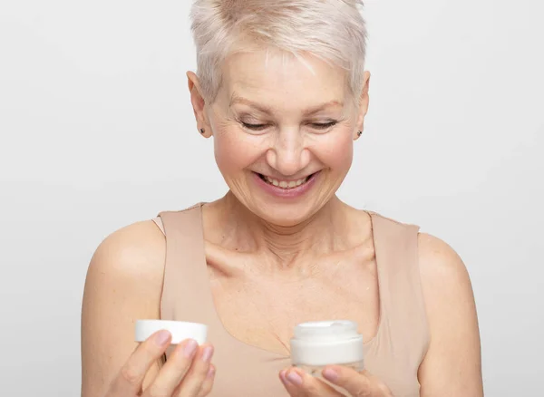Elderly Woman Holds Jar Cream Opens Smiles Concept Self Care — Stock Photo, Image