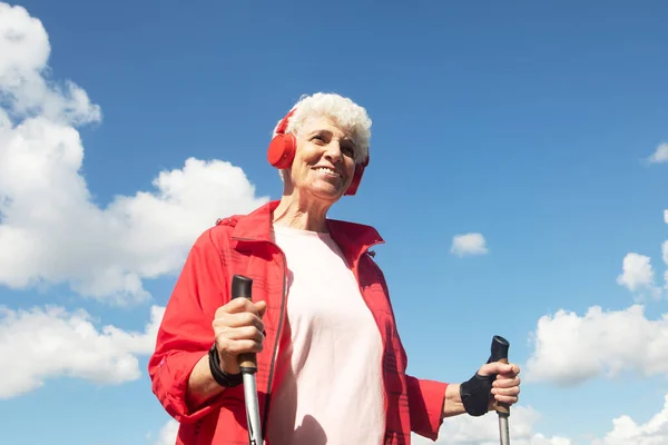 Elderly Happy Pensionerkas Woman Engaged Nordic Walking Sticks Listens Music — Fotografia de Stock