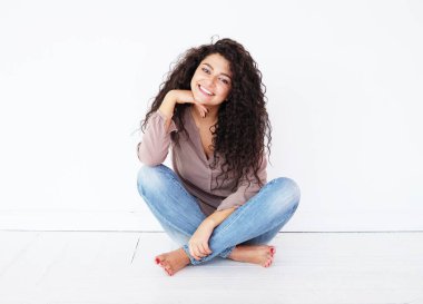 young smiling african woman wearing casual shirt, feel happy and smiling, over white background, lifestyle concept.