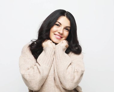 beautiful young woman smiling broadly over white background