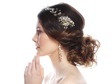 Jewelry, luxury, wedding and people concept: young bride with gorgeous diadem in her hair. Portrait over white background.
