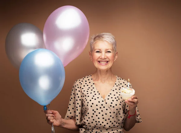 Beauitful Happy Elderly Female Cupcake Candle Balloons Her Hands Portrait — ストック写真