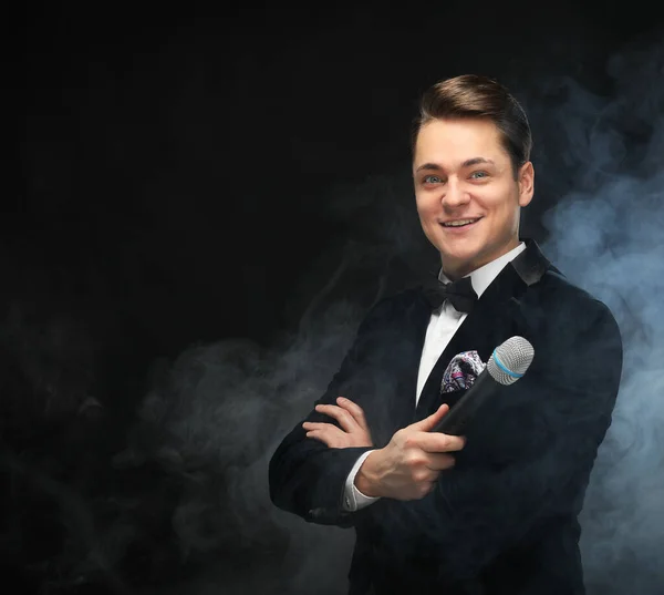 Stylish Young Man Tuxedo Holding Microphone Posing Dark Background Smoke — Stock Photo, Image