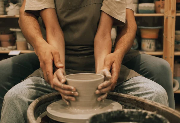 Couple mold ceramic vase in a pottery workshop, hands close up. The concept of hobbies, lifestyle and relationships.