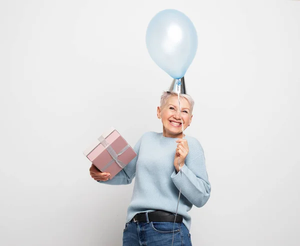 Happy Elderly Woman Short Hair Wearing Party Hat Holding Blue — Stock Photo, Image