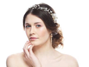 jewelry, luxury, wedding and people concept: young bride with gorgeous diadem in her hair. Portrait over white background.