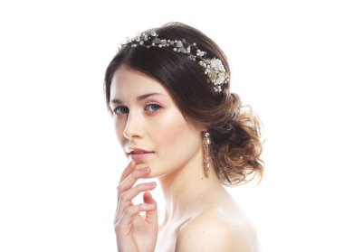 jewelry, luxury, wedding and people concept: young bride with gorgeous diadem in her hair. Portrait over white background.