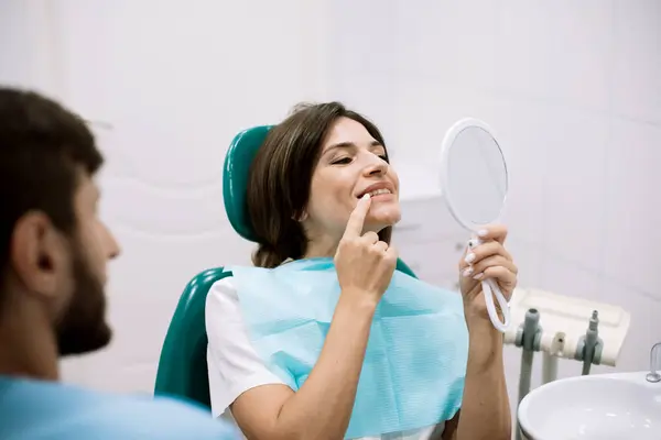 Young Female Patient Holding Mirror Looking His Beautiful Smile Sitting — Stock Photo, Image