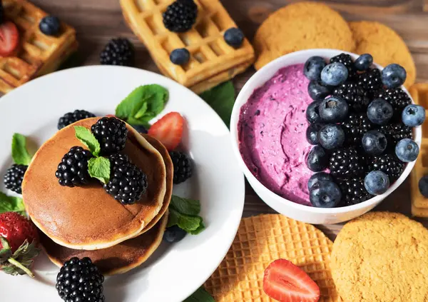 Pancakes for breakfast with blackberries. Fluffy and delicious pancakes and and in berry curd. Healthy fresh food.