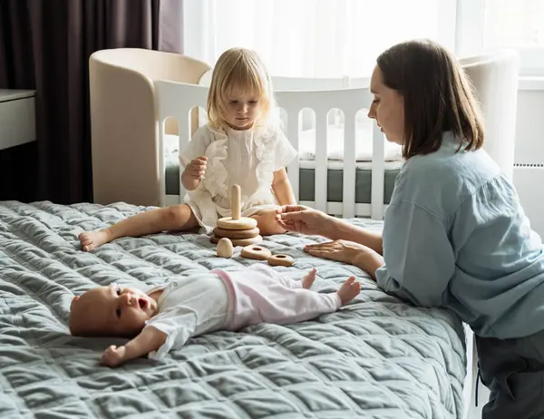Young Mother Baby Child Bed Next Two Year Old Girl — Stock Photo, Image