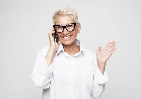 Surprised Aged Woman Short Hair Glasses Using Phone Isolated Grey — Stock Photo, Image