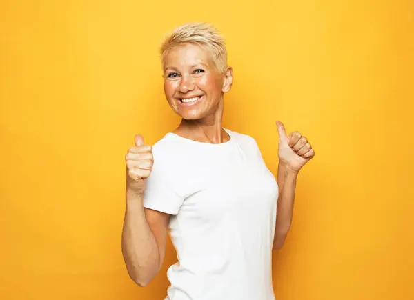 Senior Happy Woman Wearing White Shirt Showing Thumbs Yellow Background — Stock Photo, Image