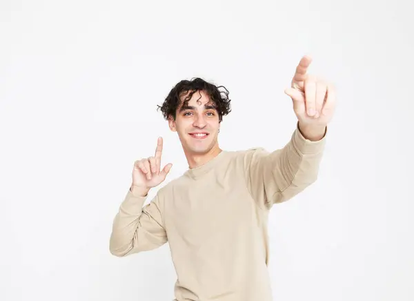 Cheerful Smiling Young Man Beige Sweater Dances White Studio Background Stock Picture