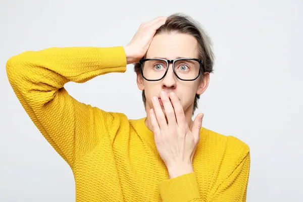 Young Man Yellow Sweater Surprised Covers His Mouth His Palm Stock Photo