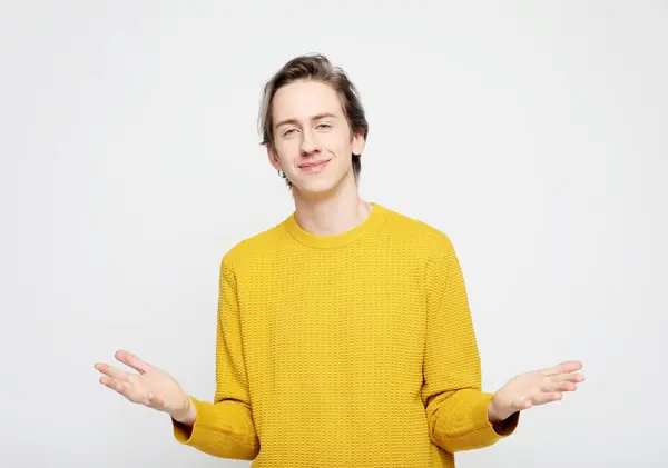 Man Yellow Sweater Raises His Arms Sides Surprise Gesture Amazement Stock Image