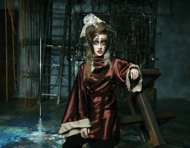 Aggressive stylish steampunk woman in a creative interior. Halloween theme.