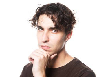 Beyaz arka planda kameraya bakan esmer bir adamın portresi.