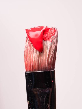 Beyaz arka planda kırmızı boya ile boya fırçası