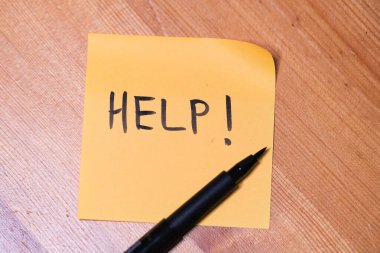 Üzerinde yardım yazan yapışkan bir not.